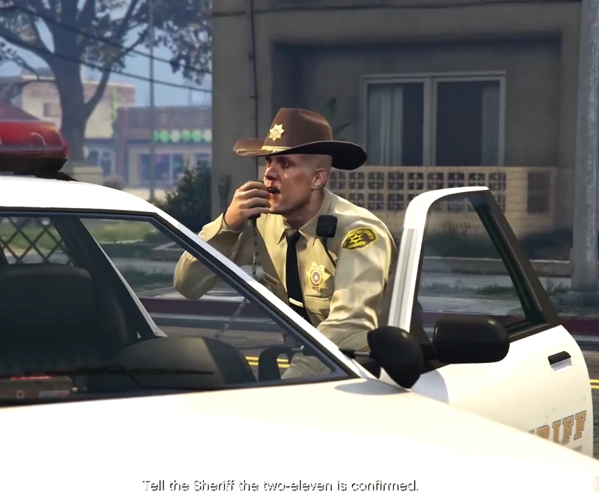 Close-up on Deputy Sheriff Kirkman's badge—Rockstar sneaking that Walking Dead love right into the LSSD roster, Grimes waiting just around the corner.